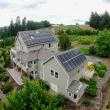 Dual solar panel array on a home surrounded by a farm.